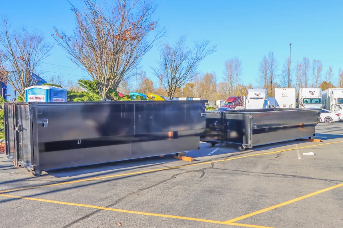 Professional dumpster rental service with roll-off container on residential driveway in Miami Lakes